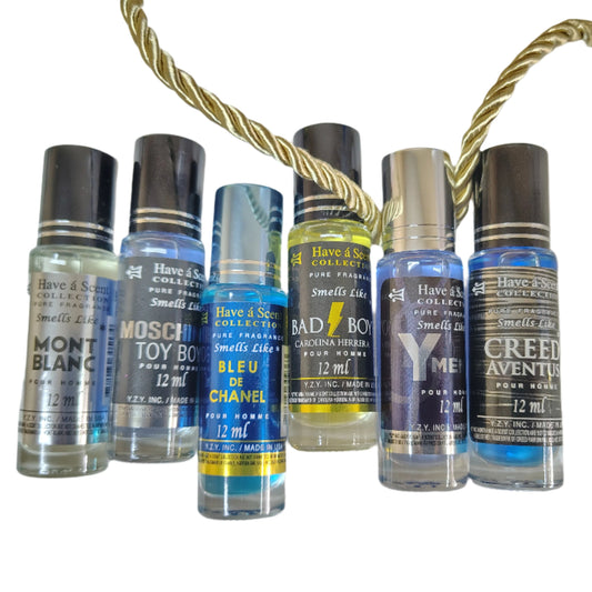 Collection of small perfume bottles with visible brand names on a white background